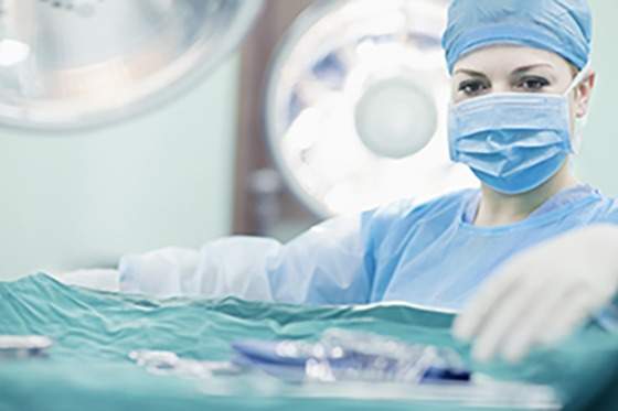 Doctor reaching for surgical tools in hospital operating room