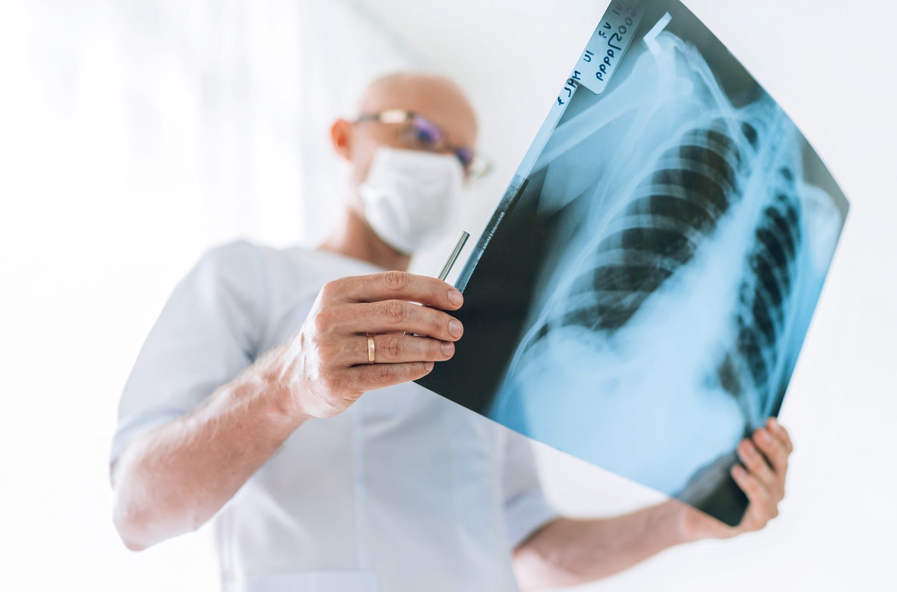 Mature male doctor examining his patient stock photo