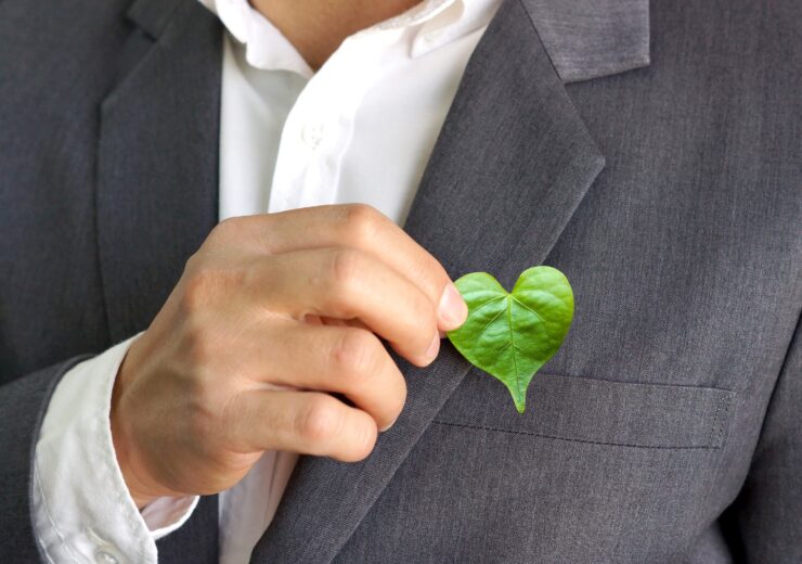 Businessman,Holding,A,Green,Heart,Leaf,/,Business,With,Corporate