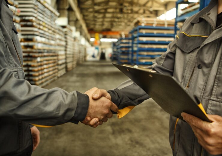 Cropped,Close,Up,Of,A,Worker,Holding,Clipboard,Shaking,Hands